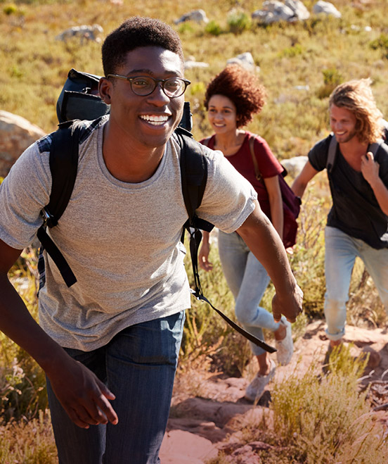 Teens hiking up a hill side