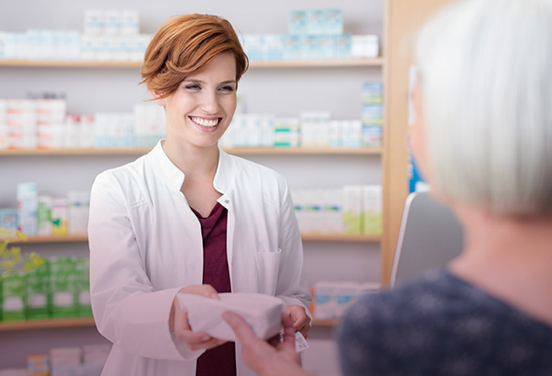 Pharmacist handing patient medication